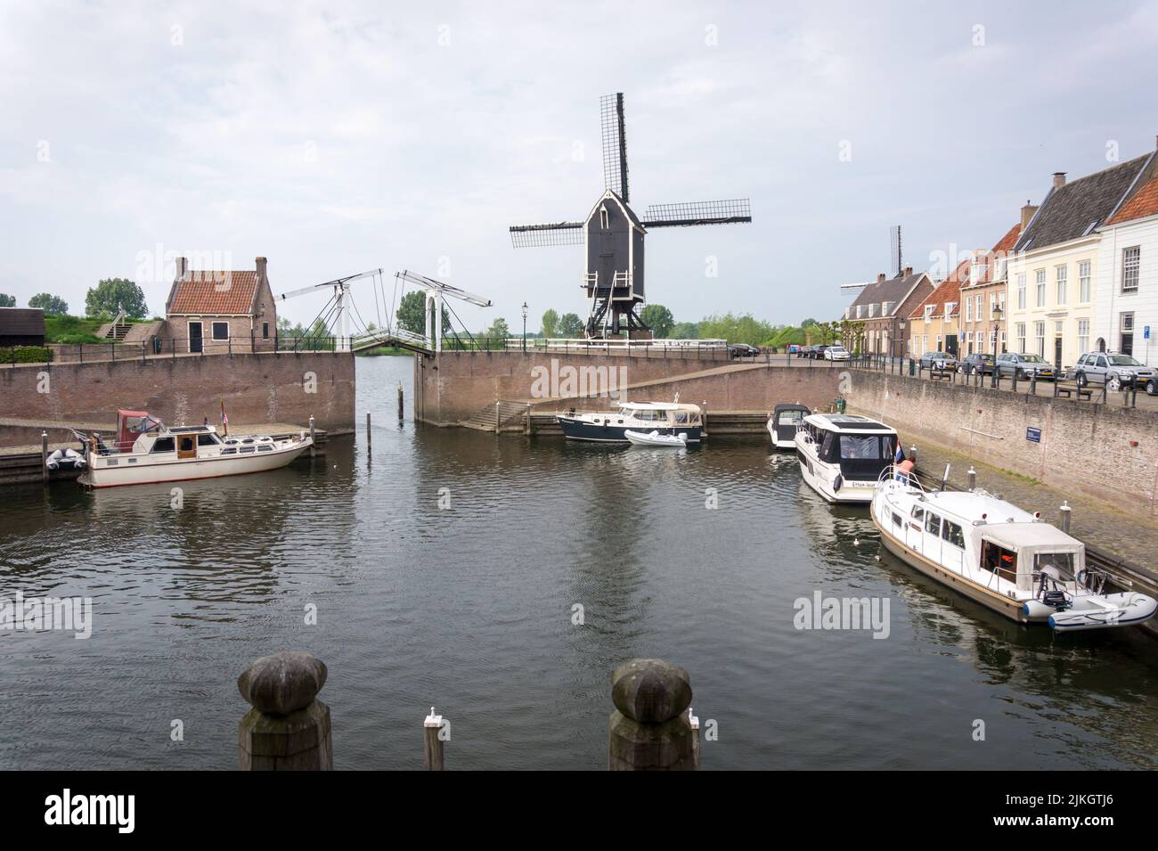 Heusden, Brabant, the Netherlands - May 7, 2022: Drawbridge and windmill at the harbor in the Dutch fortress city Heusden. Stock Photo