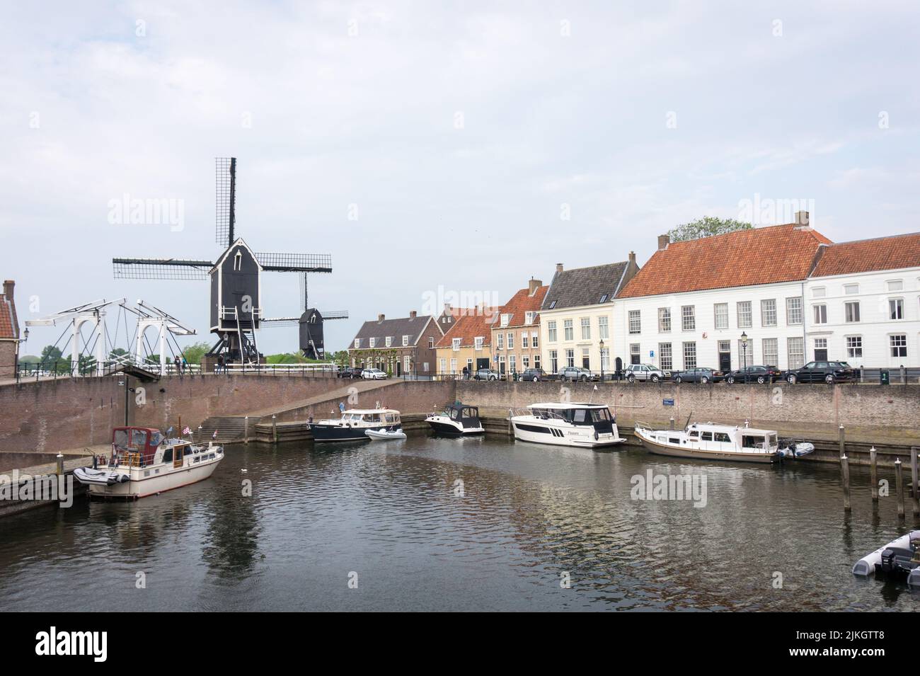 Heusden, Brabant, the Netherlands - May 7, 2022: Drawbridge and windmill at the harbor with boats in a beautiful fortress city Heusden. Stock Photo