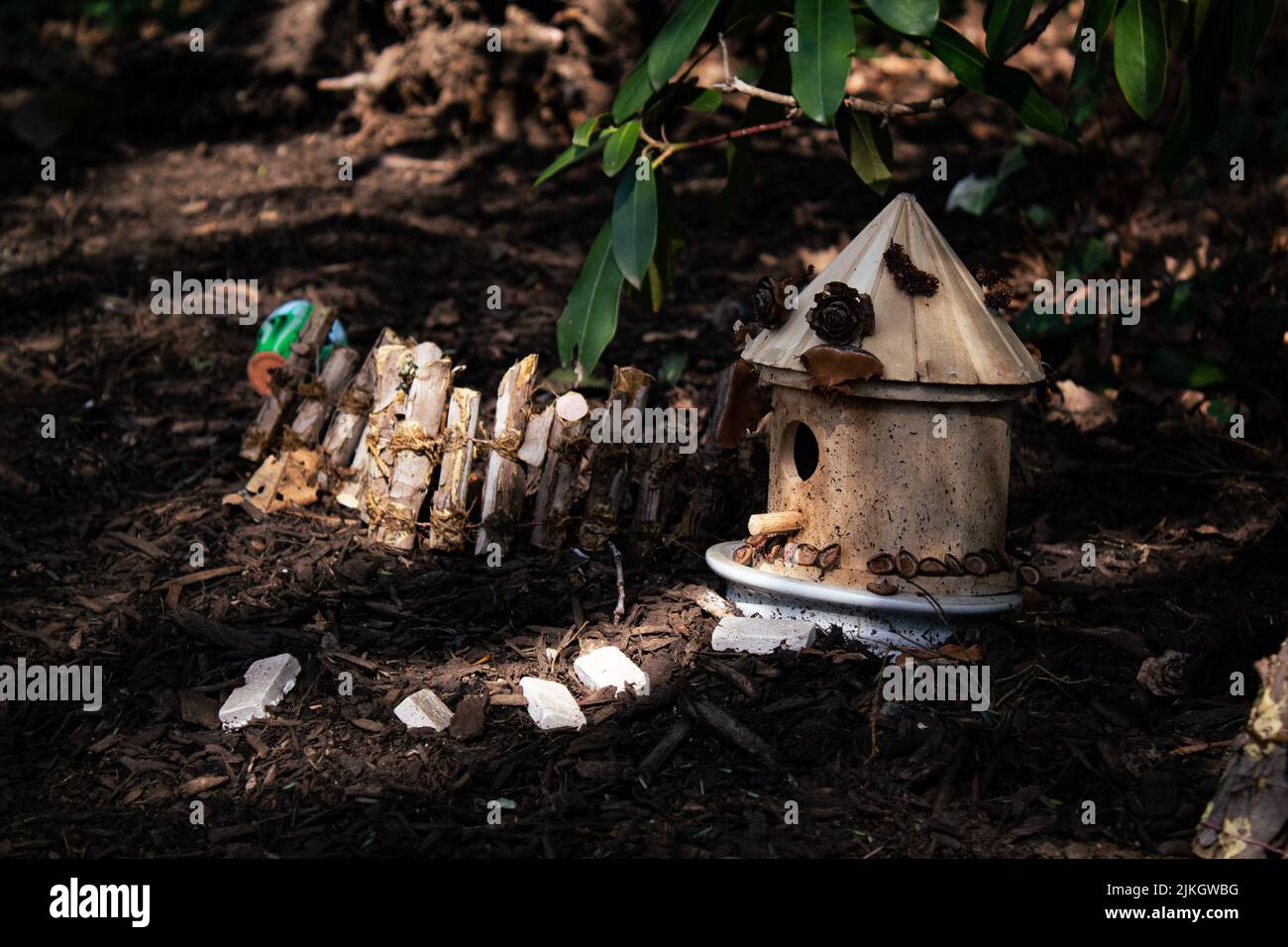 A small round wooden birdhouse in the garden Stock Photo