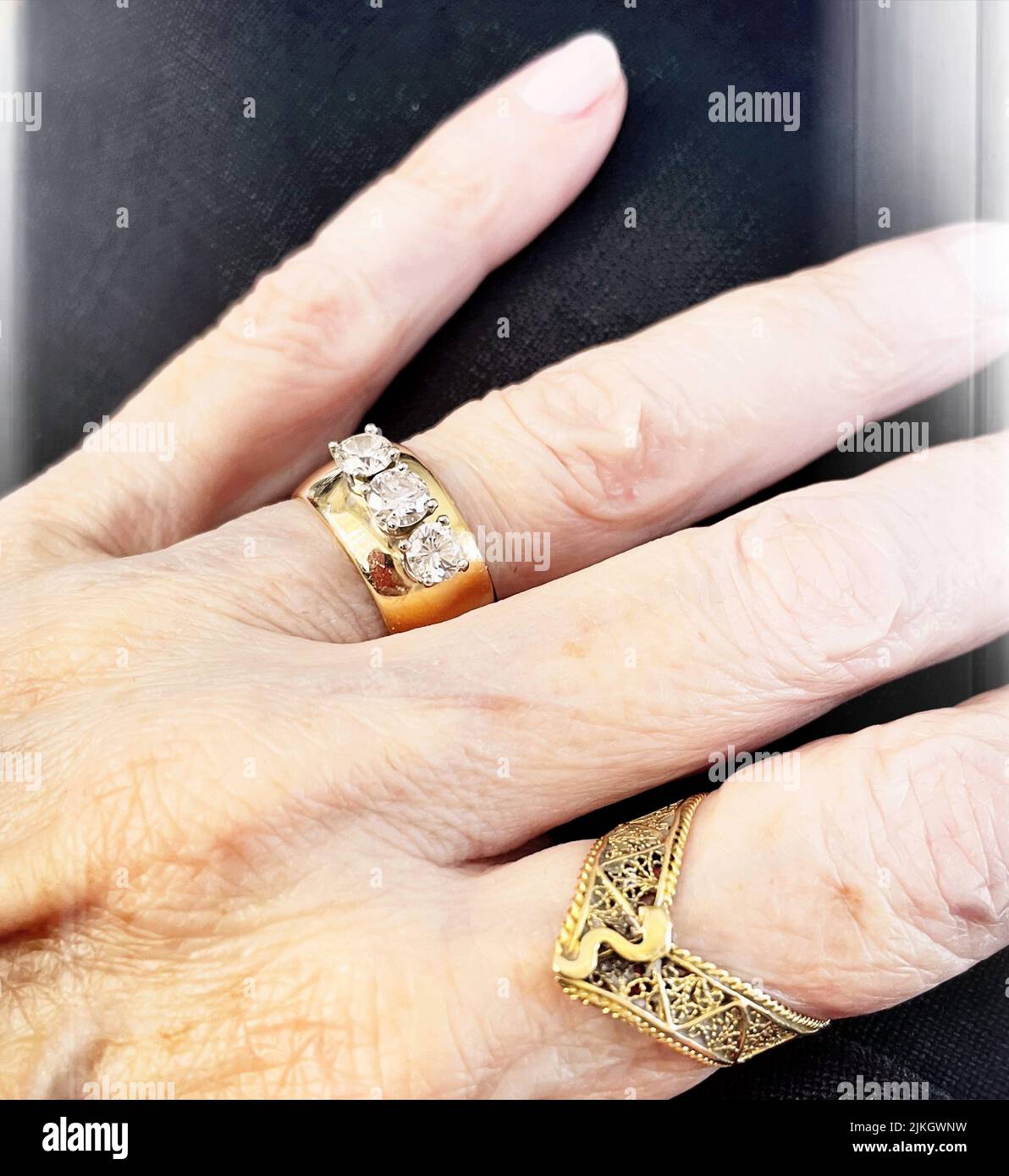 Senior woman wears a beautiful three diamond wedding band, USA  2022 Stock Photo