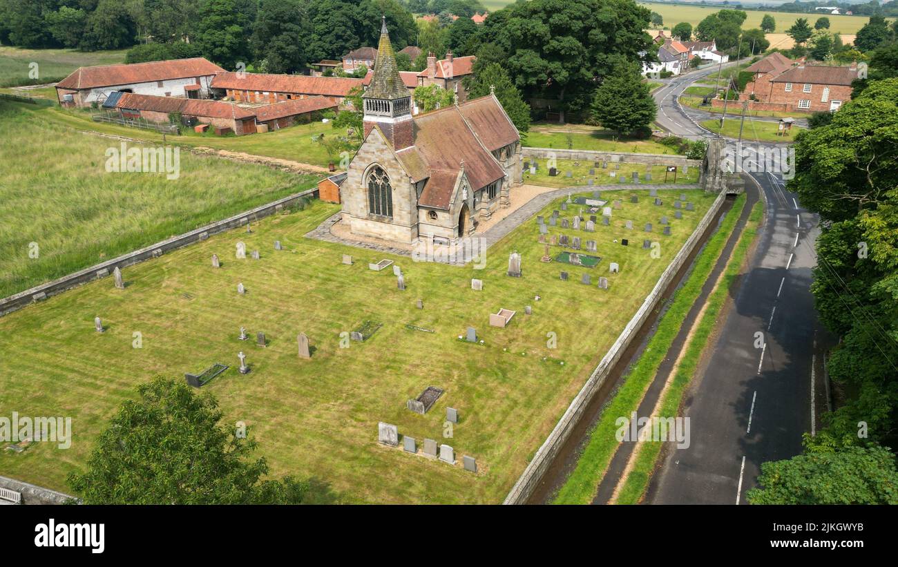 An aerial view of Village Church surrounded by cemetery and greenery