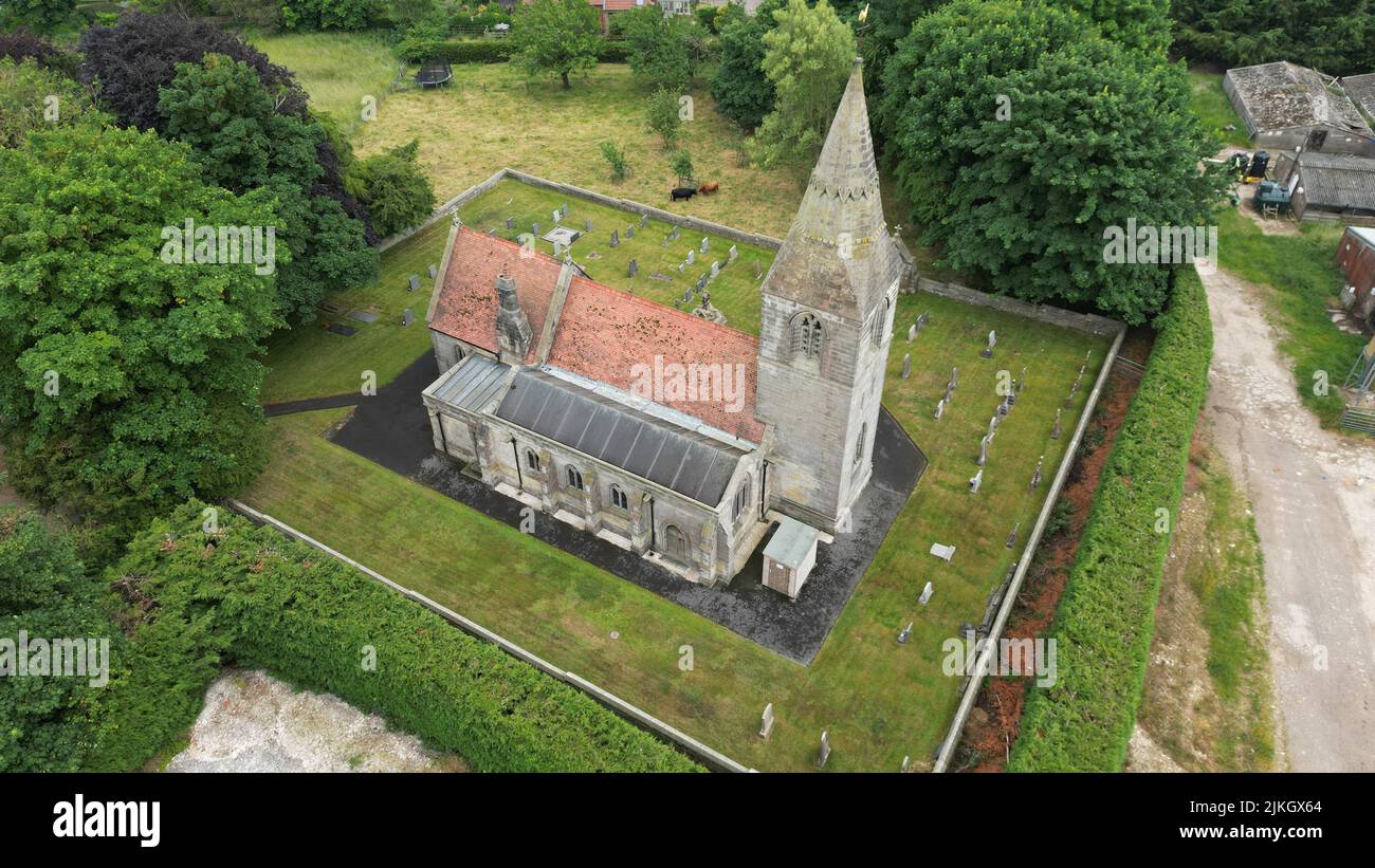 An aerial view of Village Church surrounded by cemetery and greenery