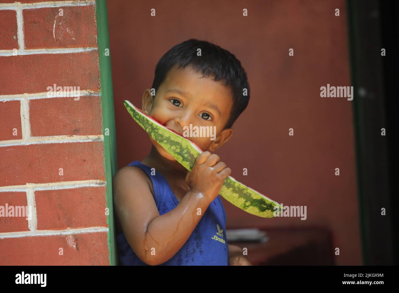 08 april 2022 Barguna, Barishal, Bangladesh. A child is eating watermelon. Stock Photo