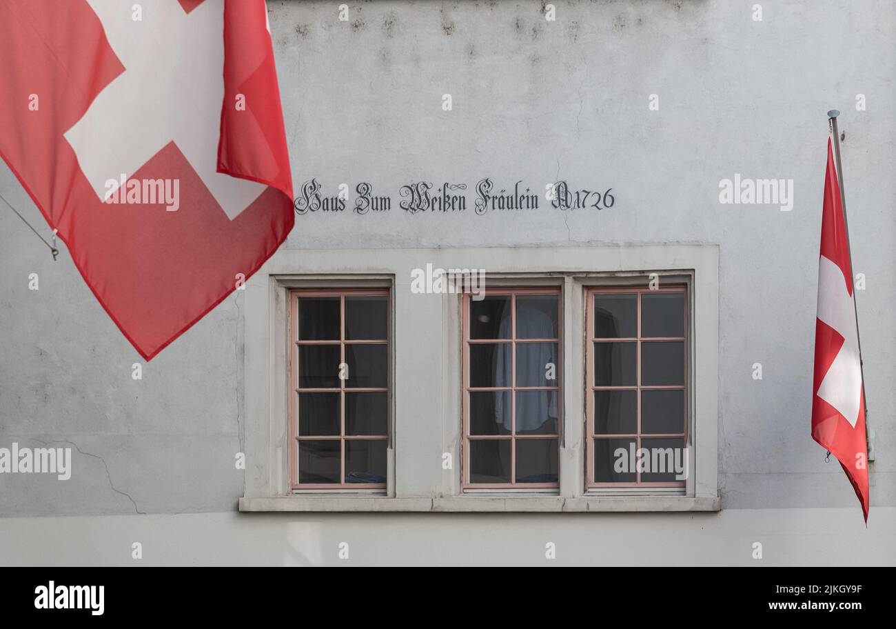 Historical houses and facades with swiss flags in the old town of