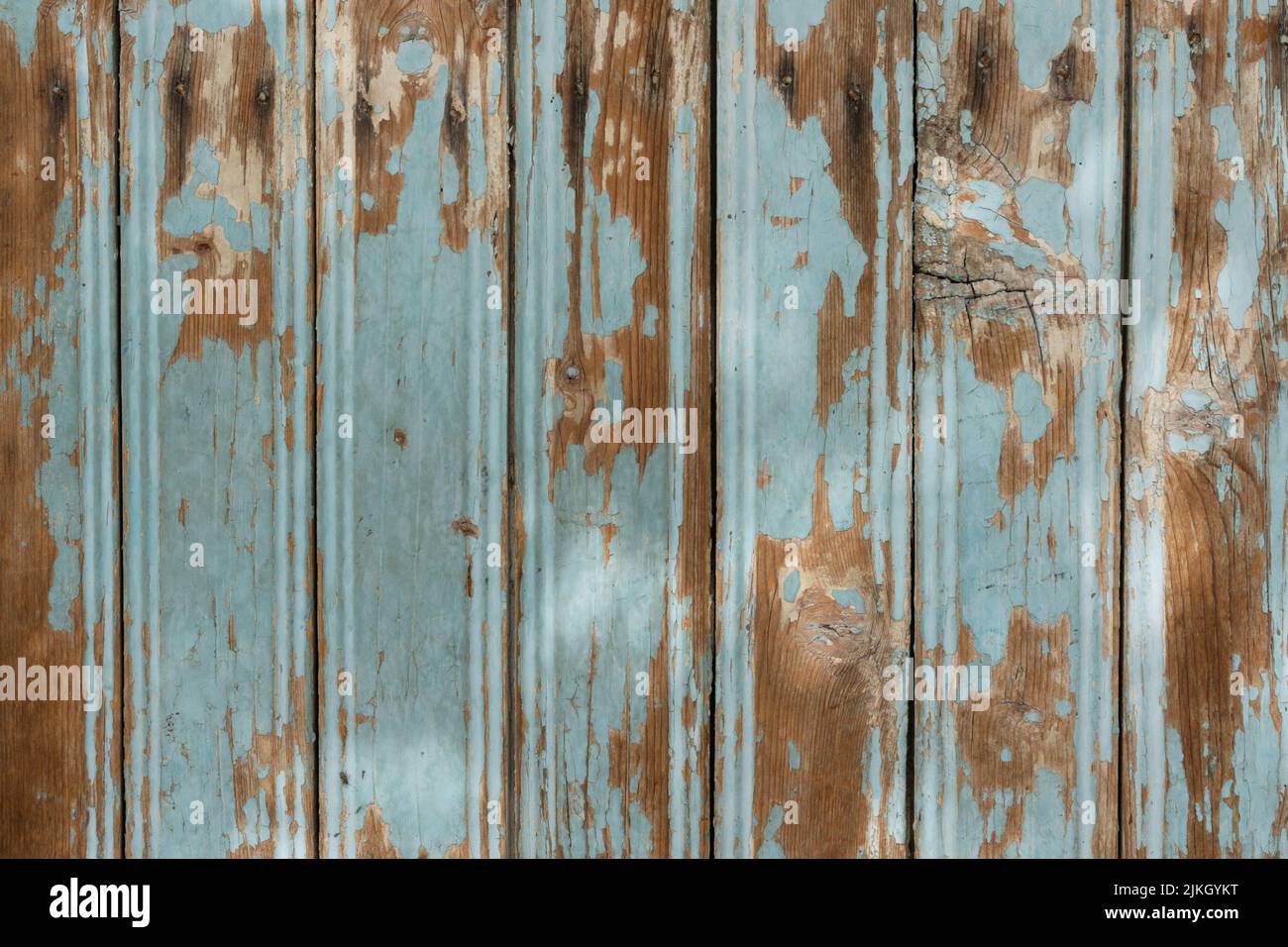 An old textured wooden surface with cracked paint and shadows Stock Photo