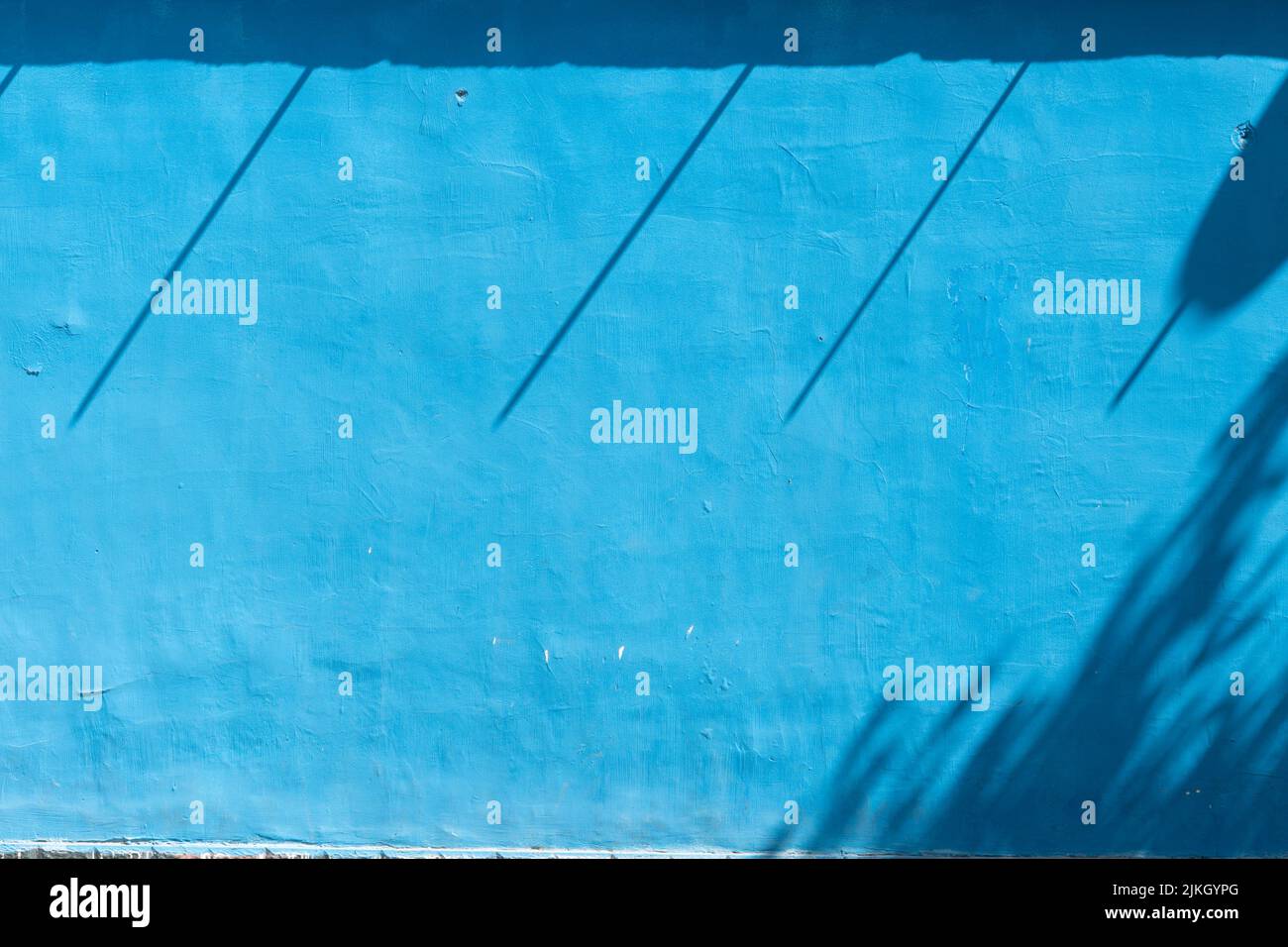 A blue wall with shadows Stock Photo