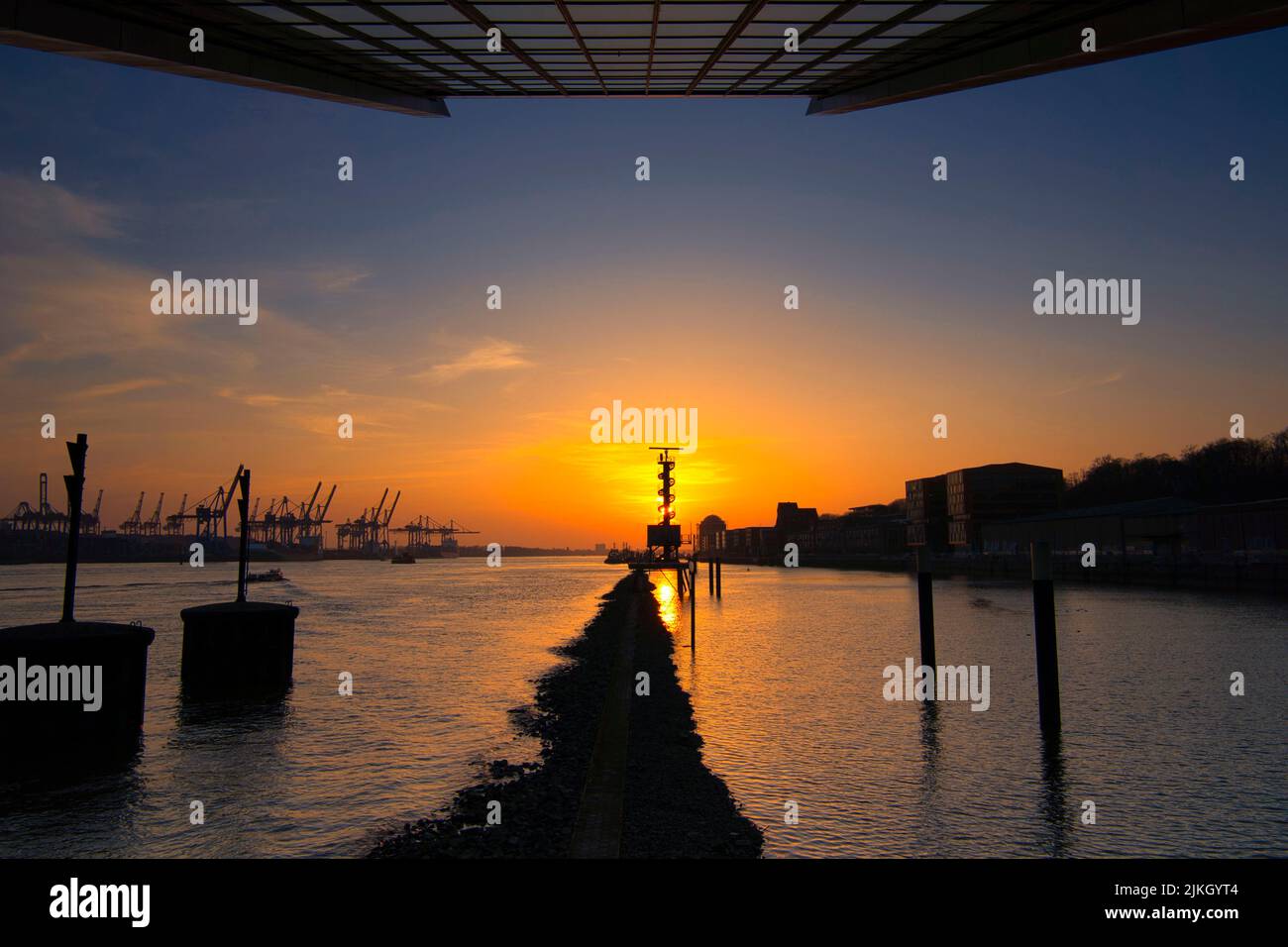 The port on Elbe river in Hamburg, Germany during a sunset Stock Photo