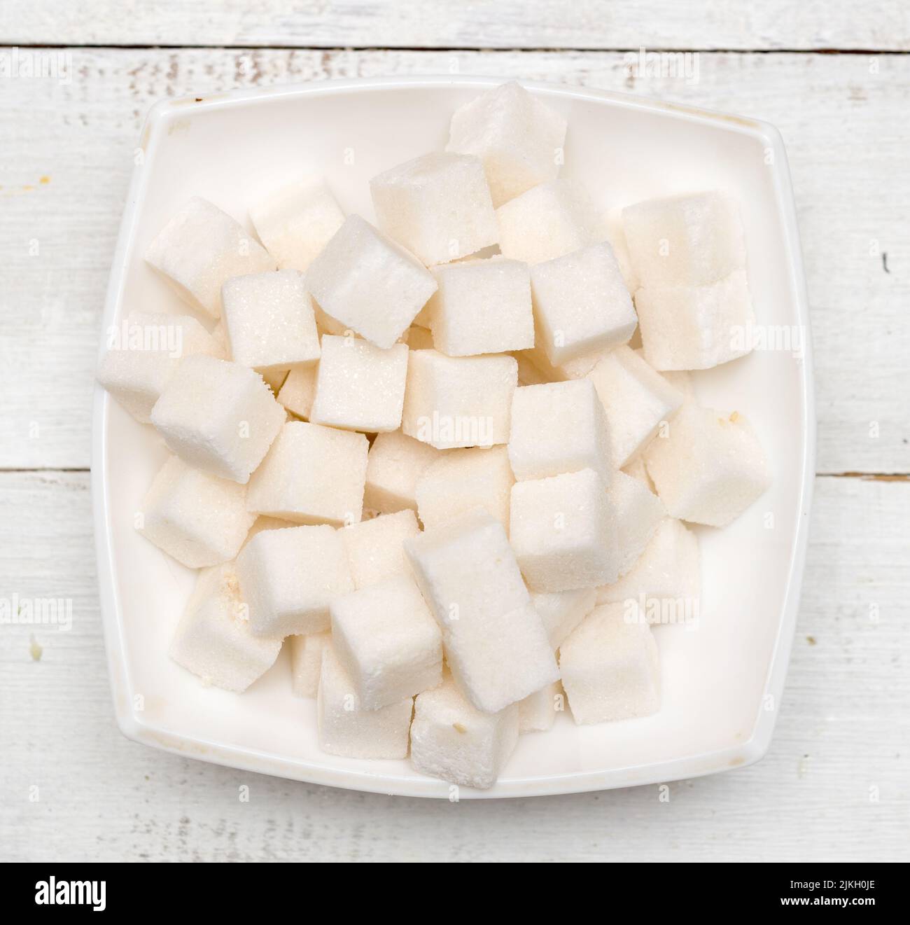 Refined sugar cubes on wooden background Stock Photo