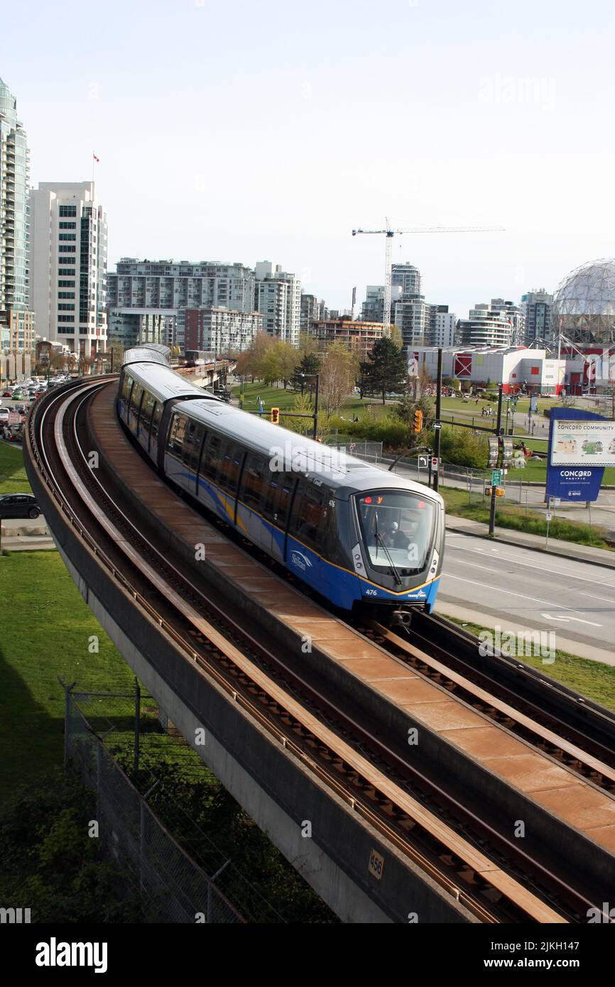 A vertical shot of a Sky Train entering downtown Vancouver, British Columbia, Canada Stock Photo