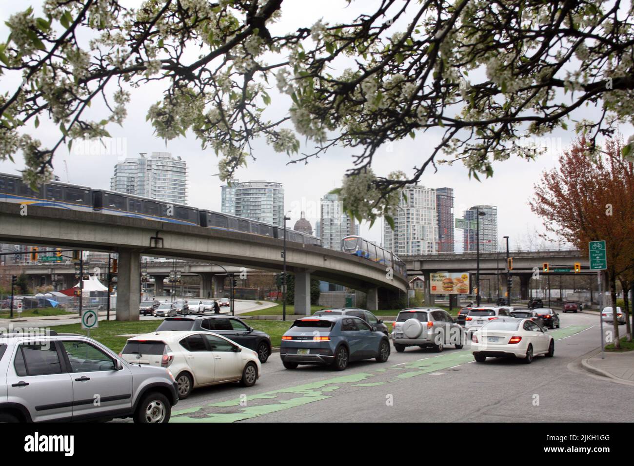The SkyTrain metro and cars in a traffic in downtown Vancouver, British