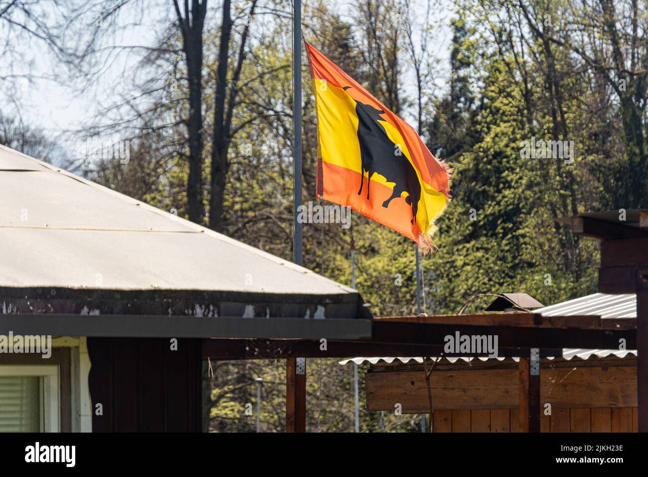 A beautiful shot of the flag of Malaga on the roof of a house Stock Photo