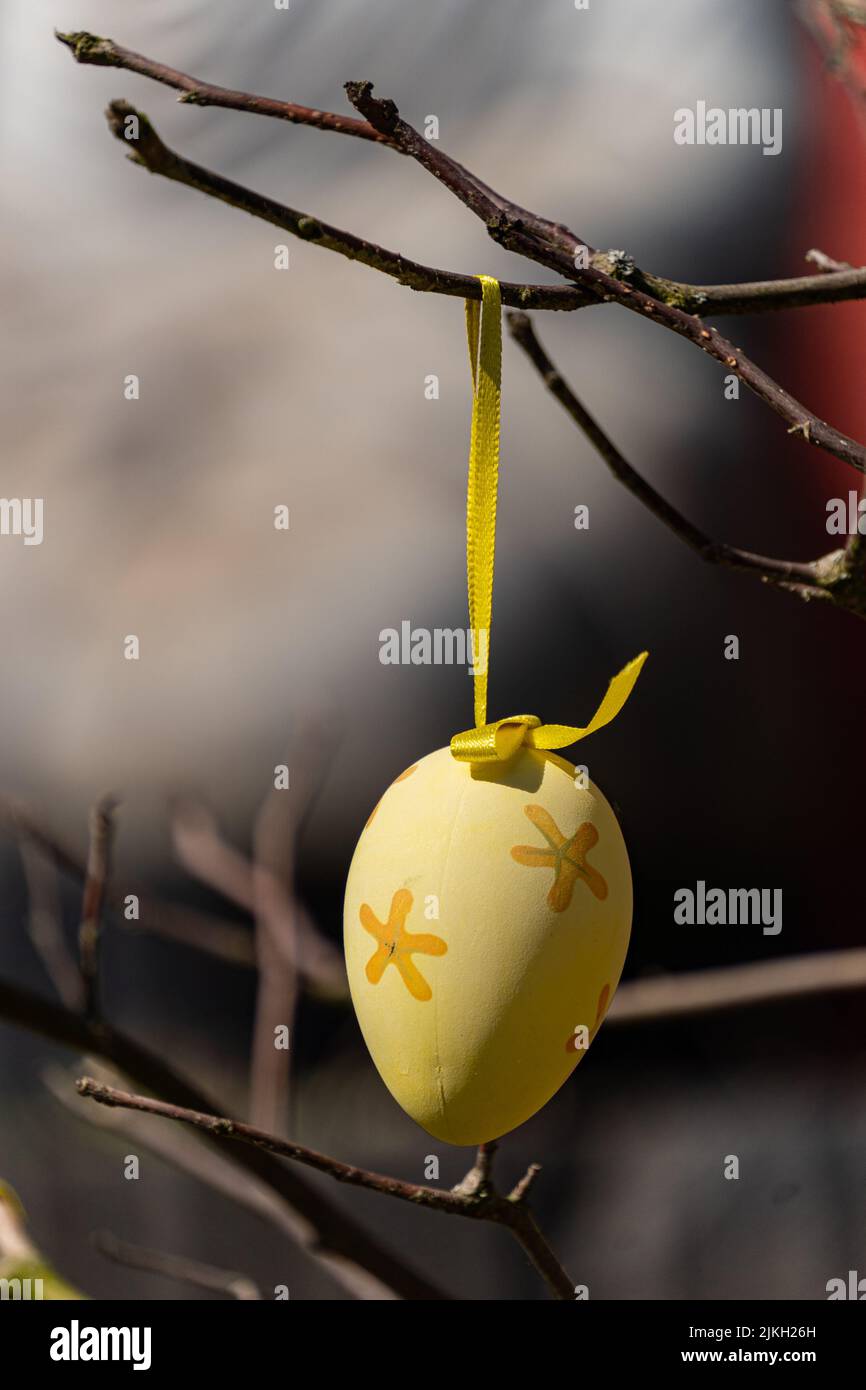 A beautiful shot of a decorative Easter egg hanging on a tree branch Stock Photo