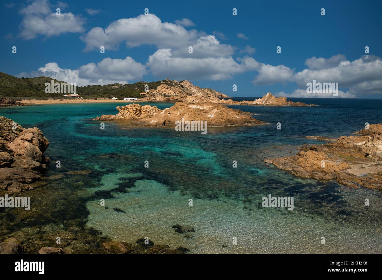 A scenic beach in Menorca with peculiar rocks in the water, Balearic ...
