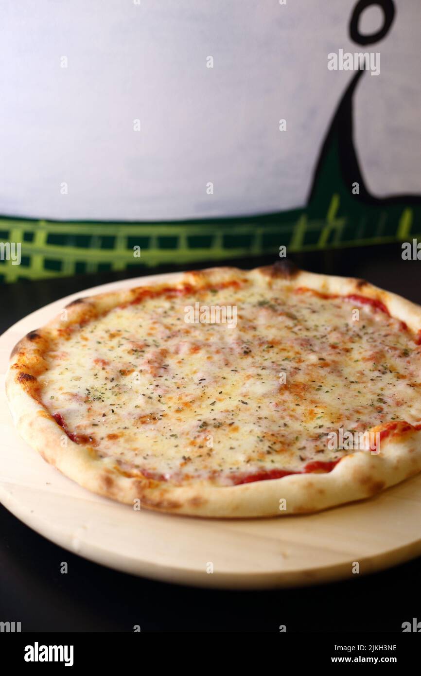 A vertical shot of Margherita pizza with tomato paste and cheese toppings Stock Photo