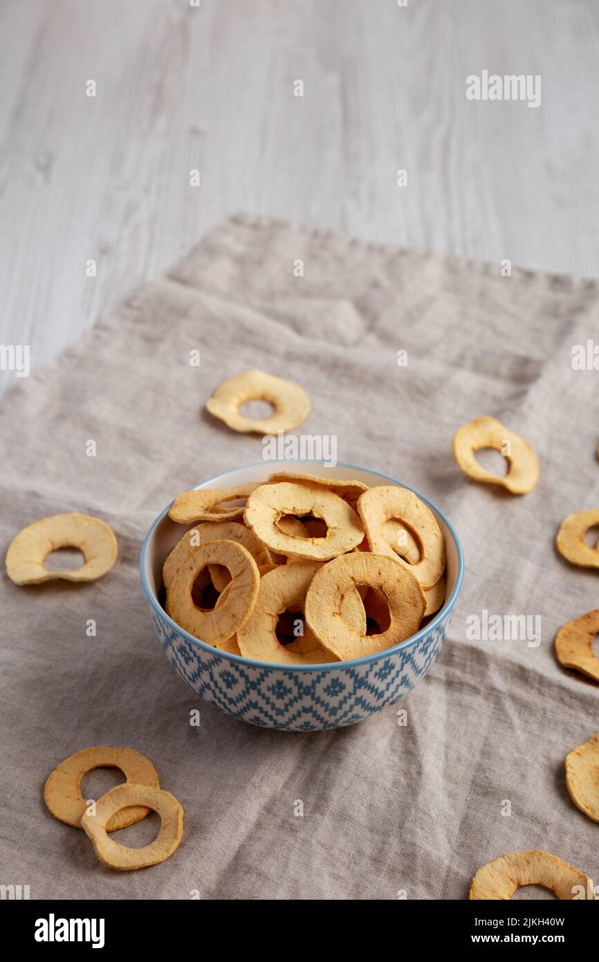 Homemade apple chips in a bowl, side view. Copy space. Stock Photo