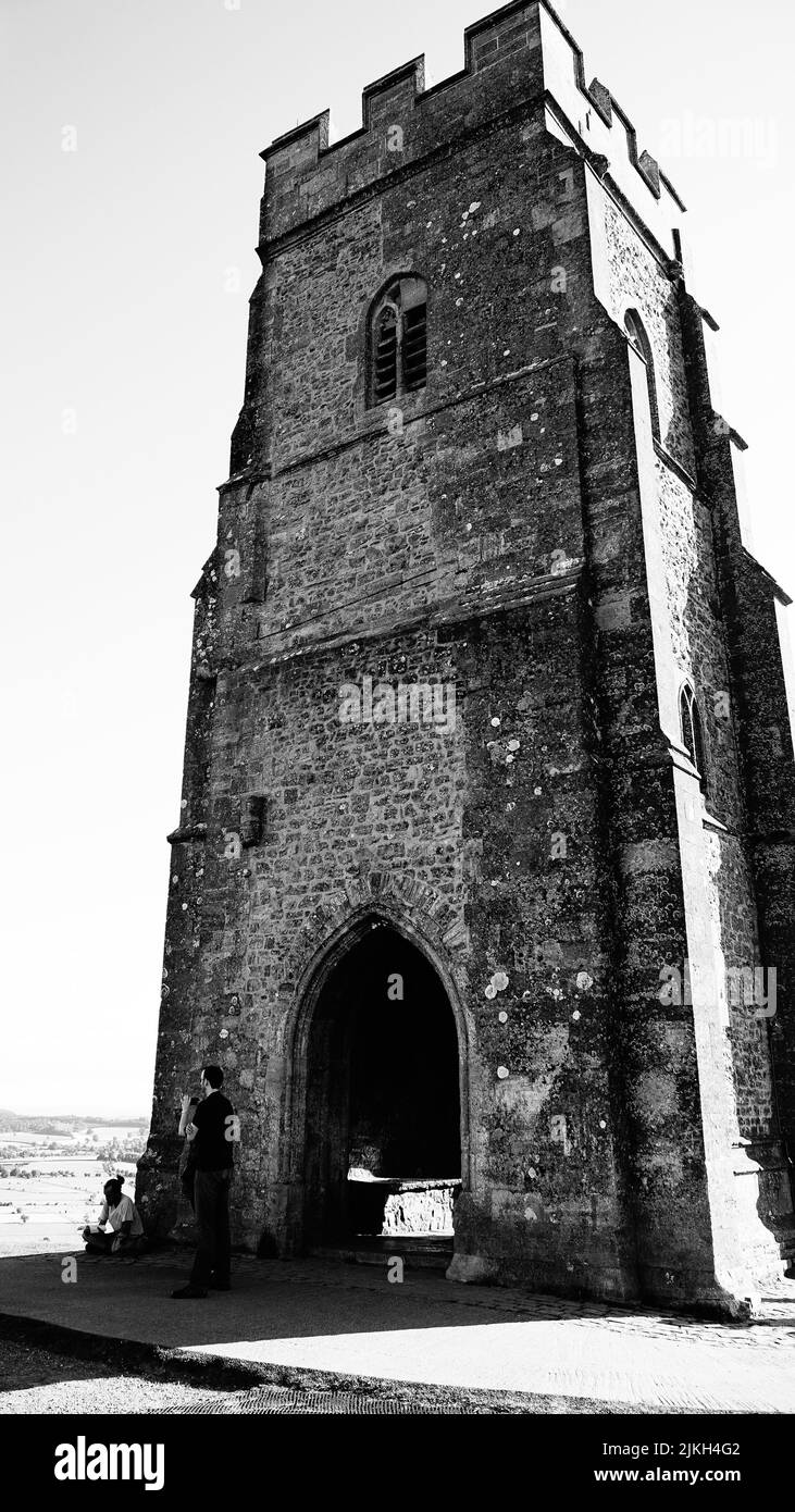 A grayscale shot of St Michael's tower on top of Glastonbury Tor hill in Somerset, England Stock Photo