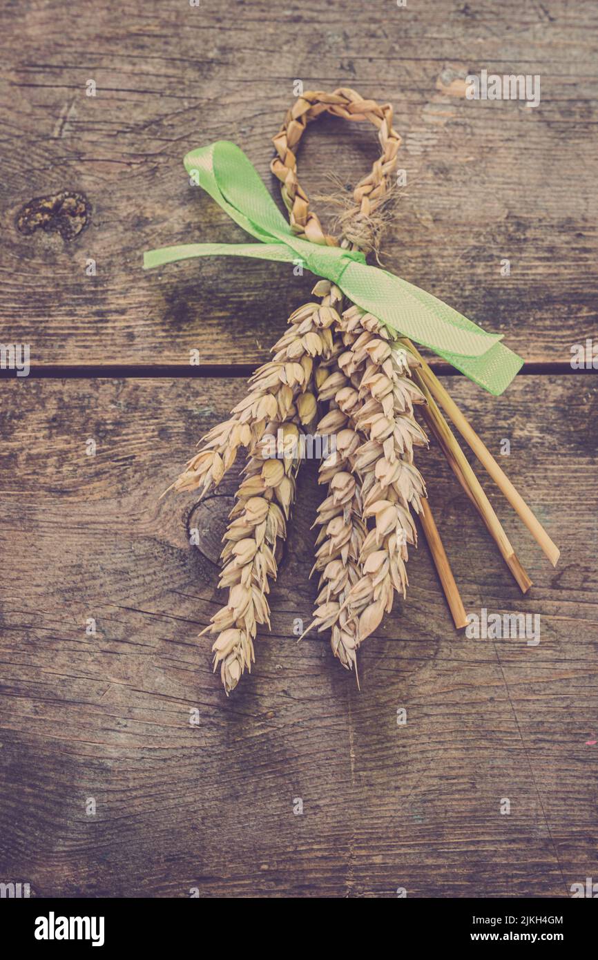 Traditional ladies harvest favours ( Corn Dollys ) tied with a coloured ribbon. Stock Photo