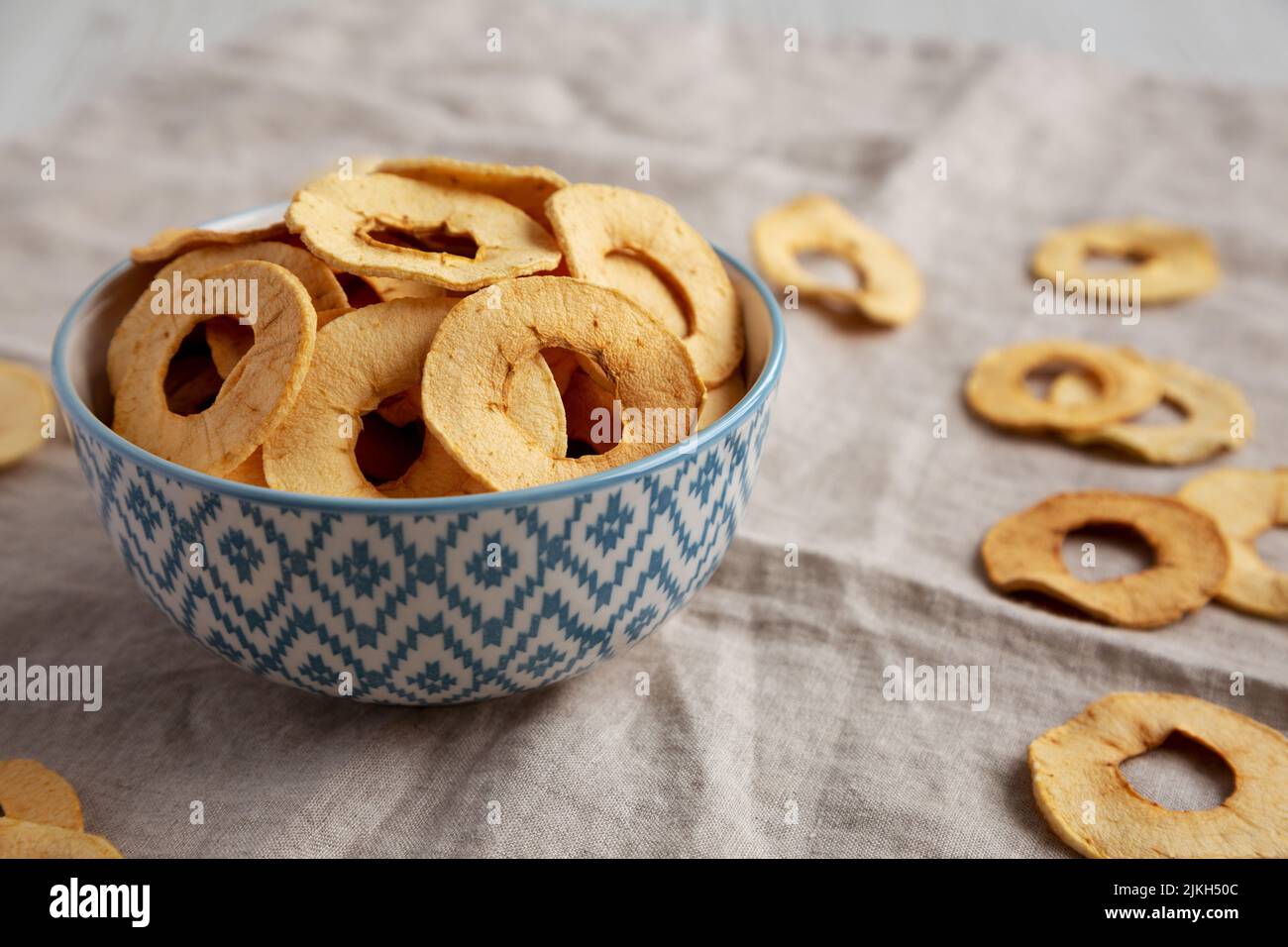 Homemade apple chips in a bowl, side view. Stock Photo