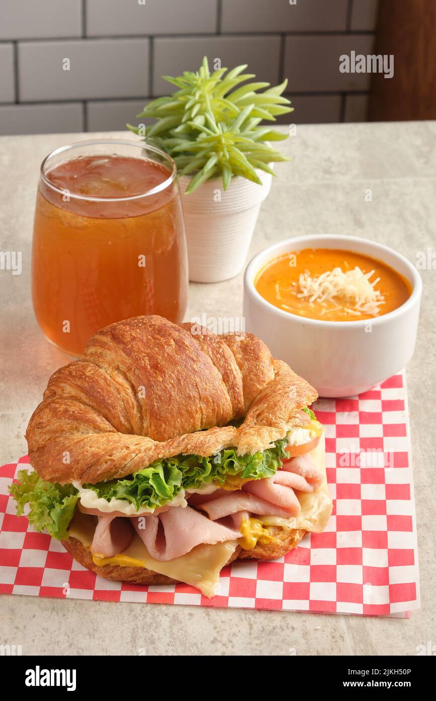 A delicious ham and cheese croissant with sauce and juice Stock Photo
