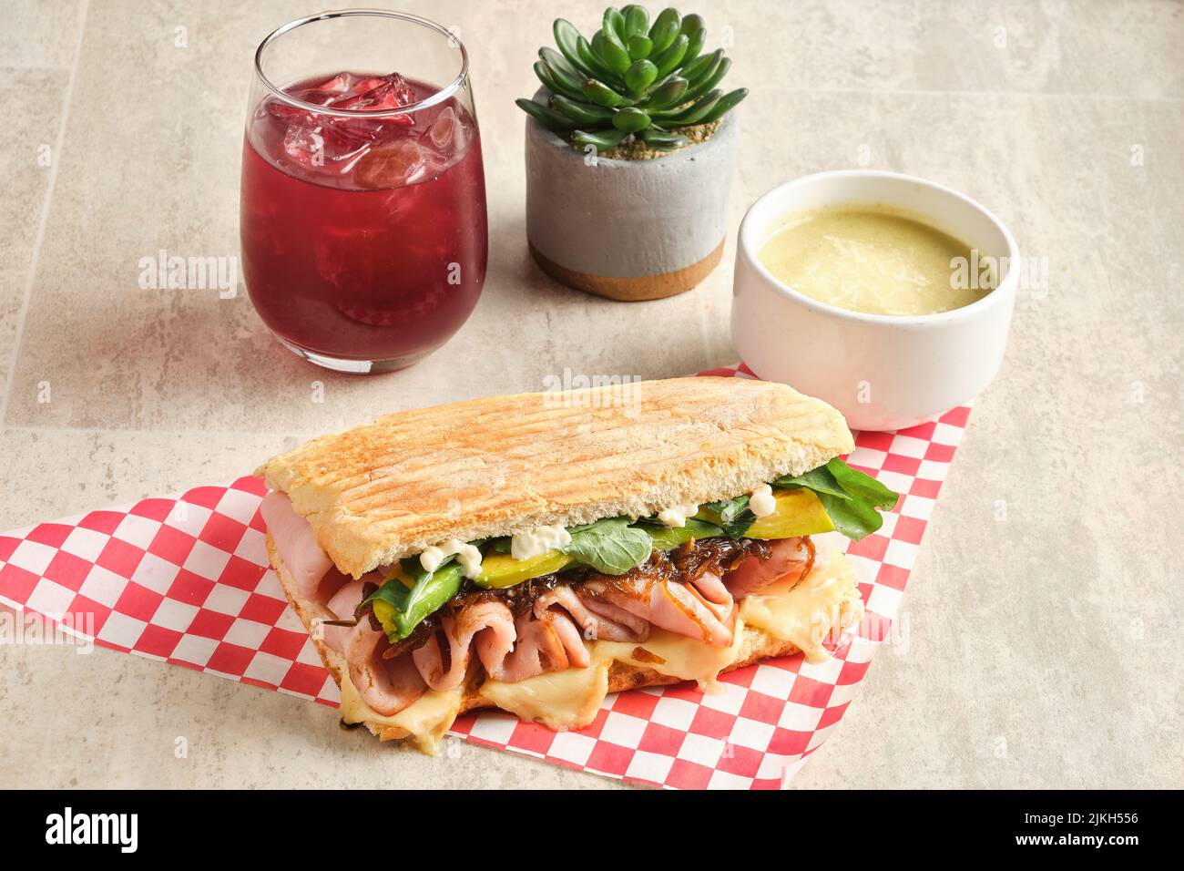 A fresh panini with ham, avocado, cheese, and spinach Stock Photo