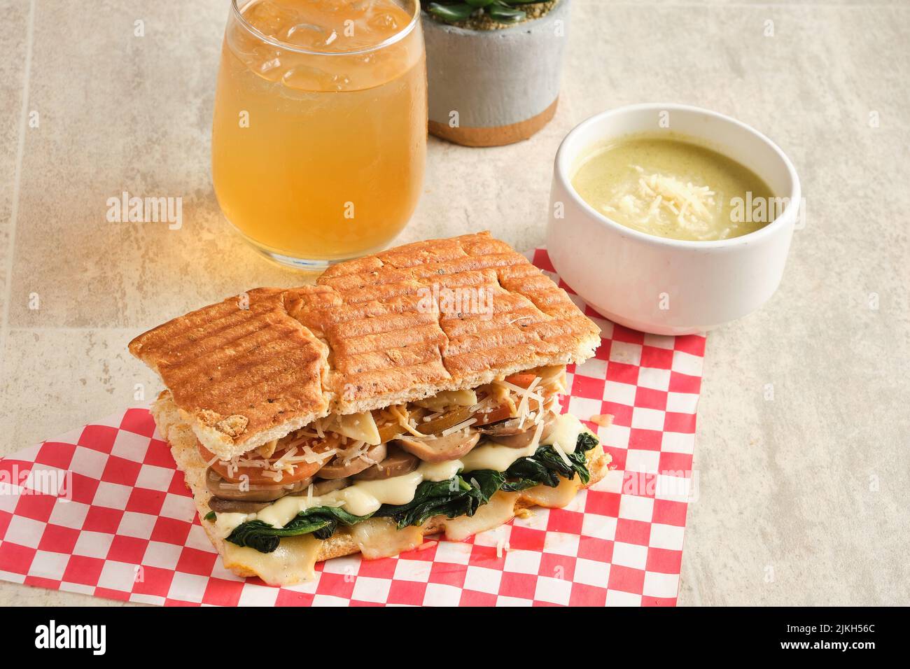 A fresh panini with spinach, mushrooms, cheese and tomatoes Stock Photo