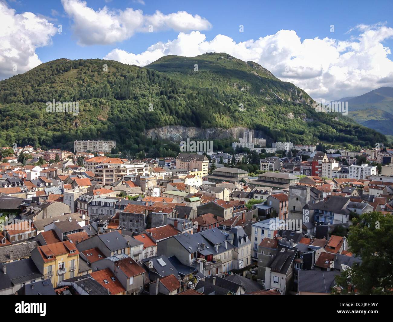 An aerial view of Lourdes city with houses surrounded by greenery under