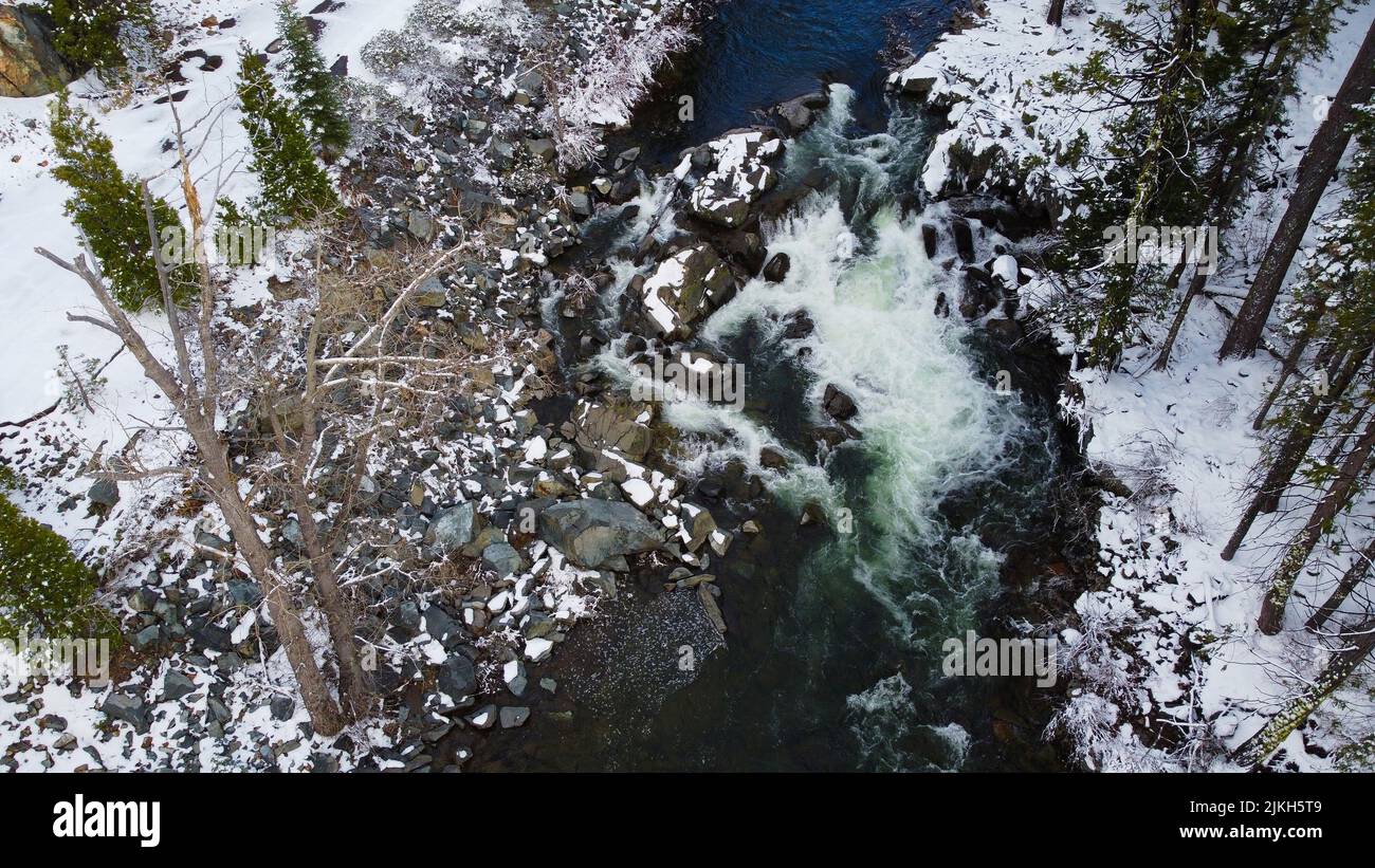 An aerial view of river running through winter forest Stock Photo - Alamy