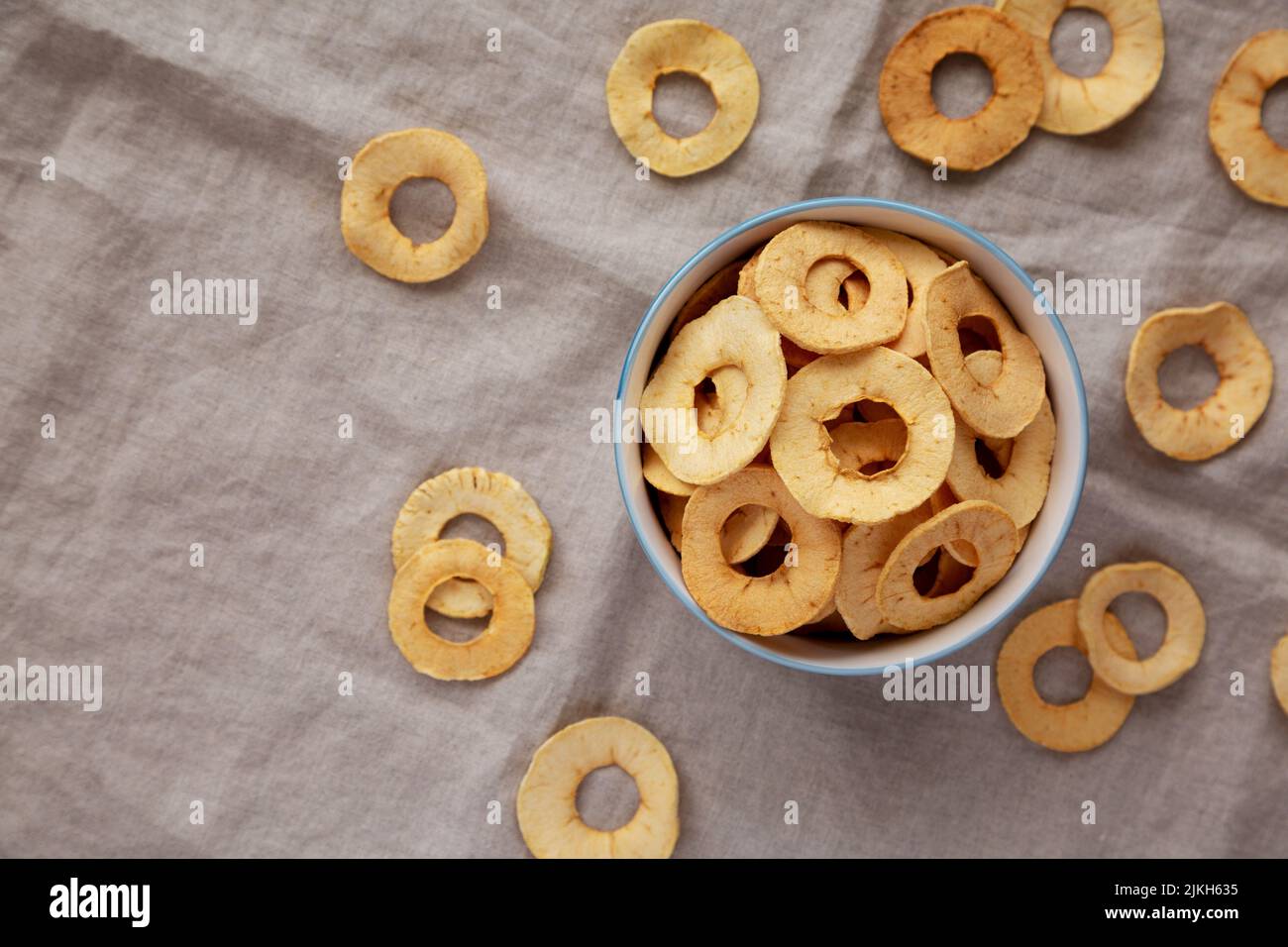 Homemade apple chips in a bowl, top view. Flat lay, overhead, from above. Copy space. Stock Photo