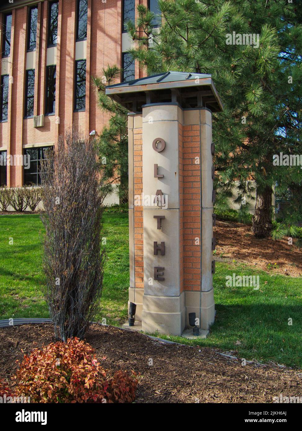 A vertical shot of Olathe sign in front of Olathe Kansas City Hall