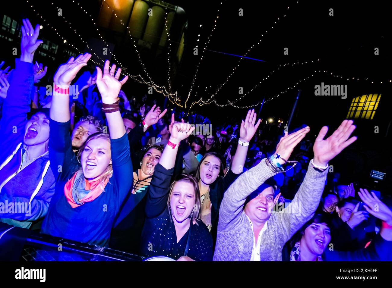 Trendy young people attending a music concert Stock Photo