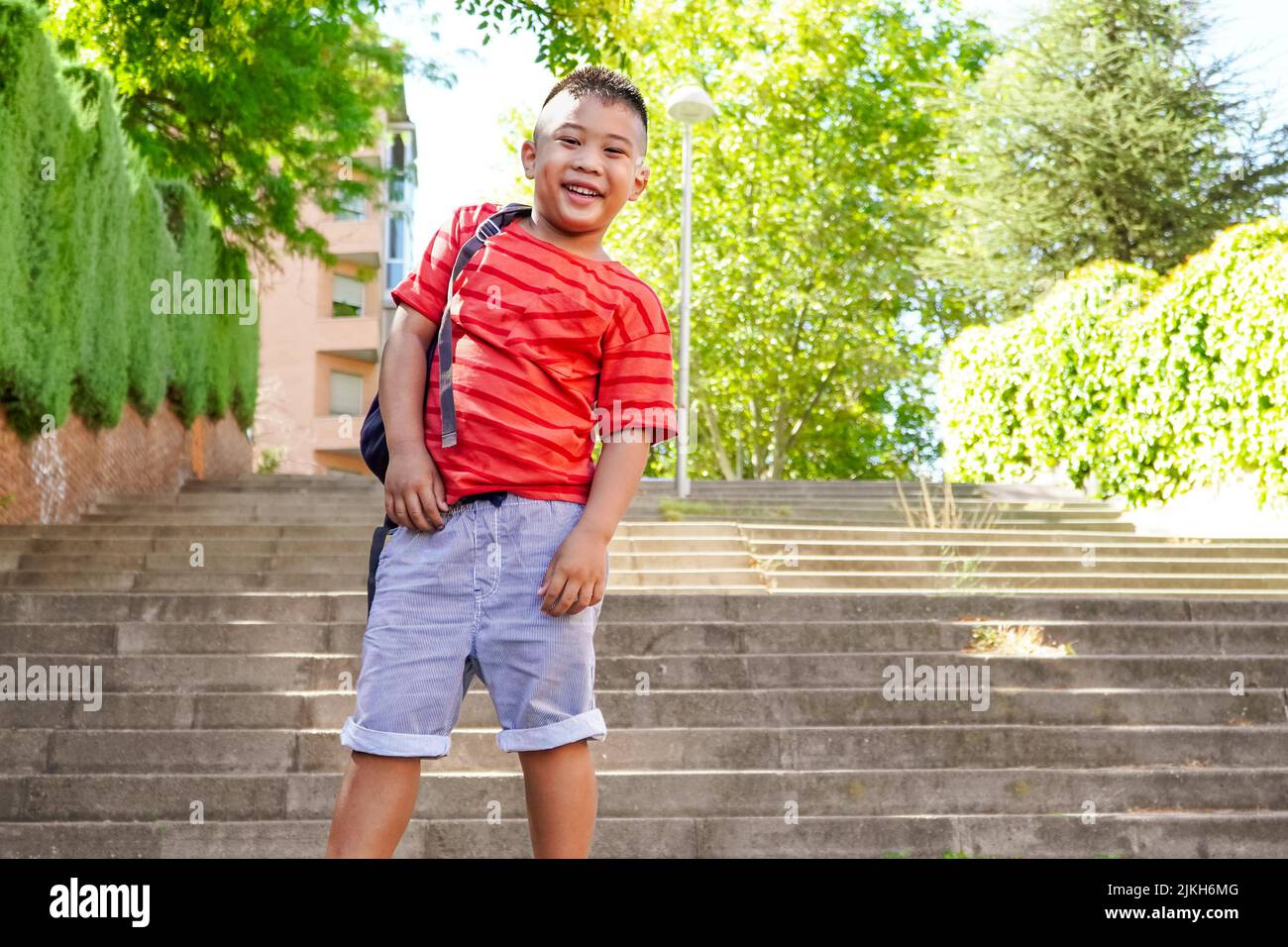 Filipino boy with backpack on the way to school. Back to school concept. Multiethnic children group Stock Photo