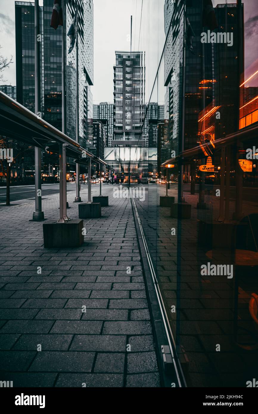 A vertical shot of a paved street between old buildings in Montreal ...
