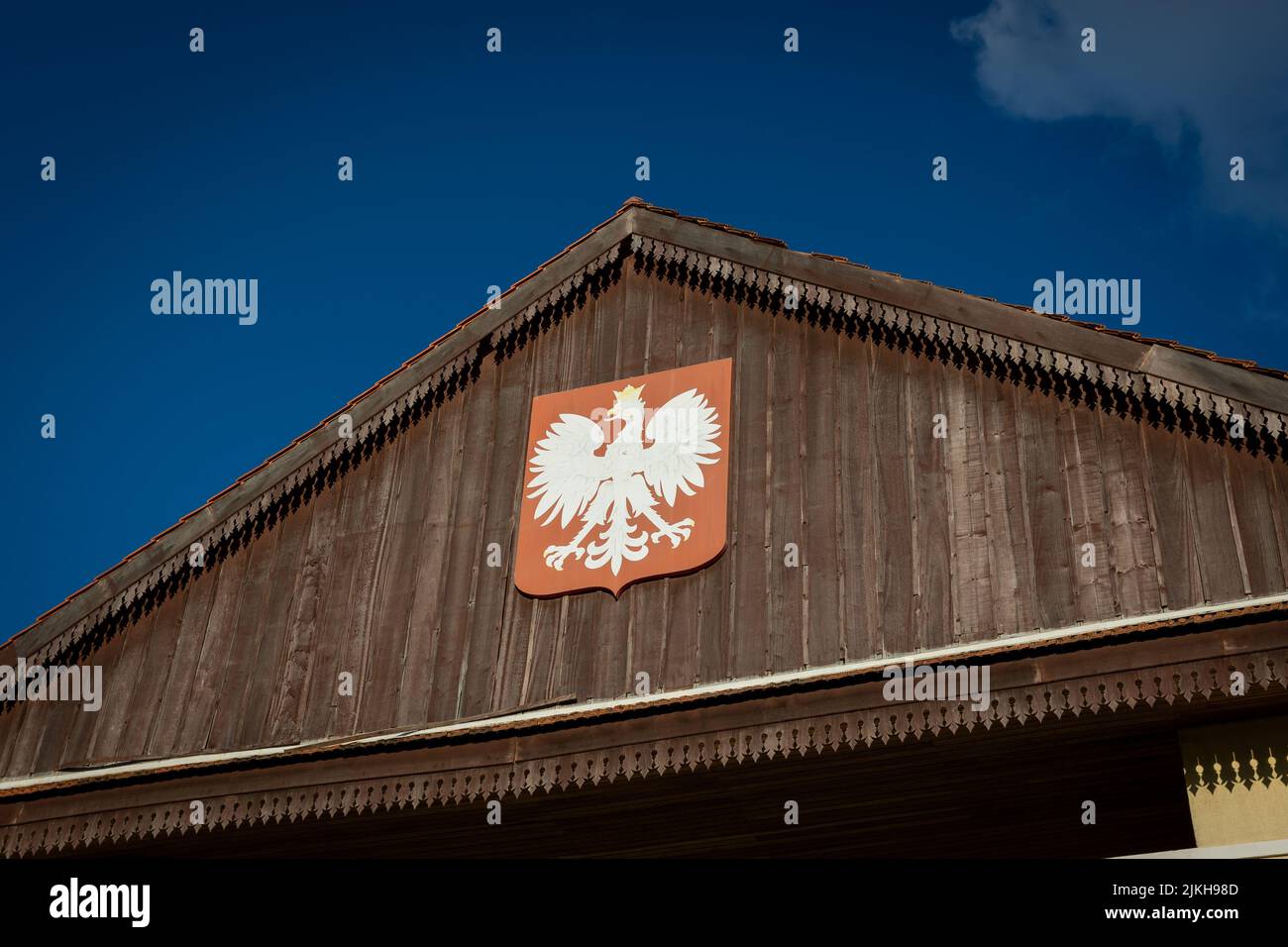 A low angle shot of the Bialystok coat of arms emblem on a wooden dome of a building Stock Photo