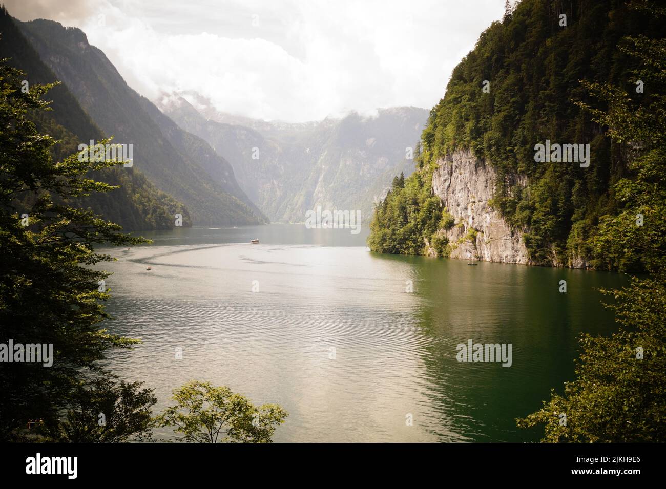 A mesmerizing view of a canal between high forested cliffs against the ...