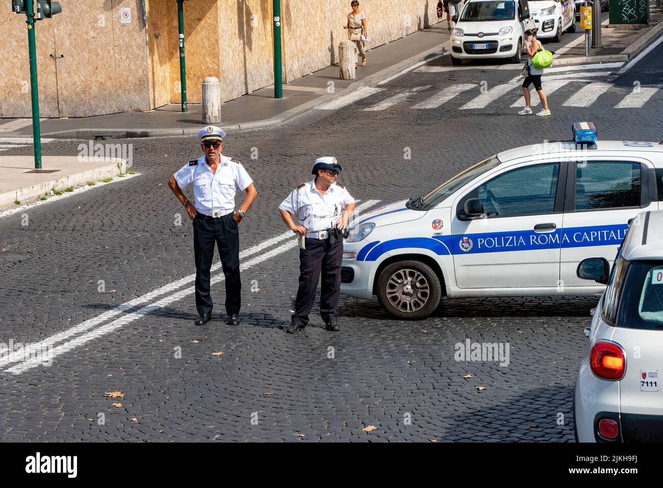 Two policemen standing at a traffic incident site in Rome, Italy Stock Photo