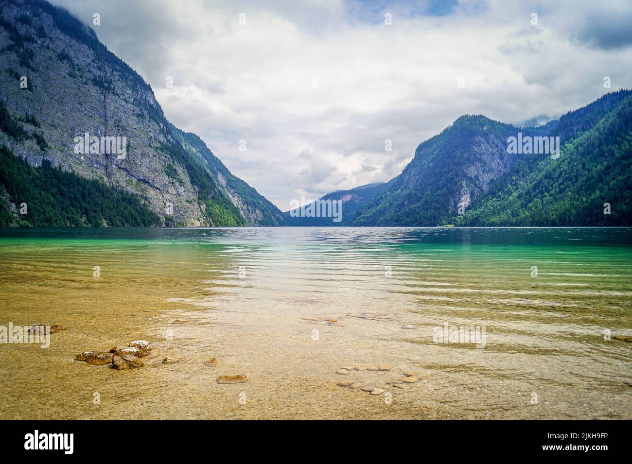 A mesmerizing view of a canal between high forested cliffs against the ...