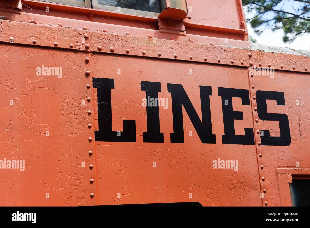 A closeup shot of the word 'LINES' painted in black on an orange metal surface Stock Photo