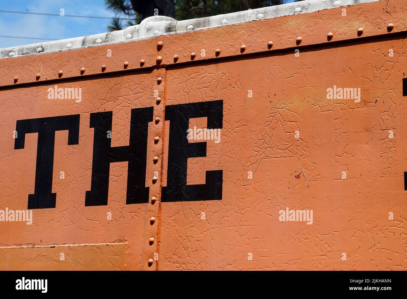 A closeup shot of a painted 'THE' sign on an orange metal wall Stock Photo