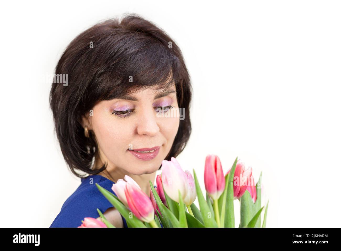 A young mother received flowers as a gift for her birthday. Isolated