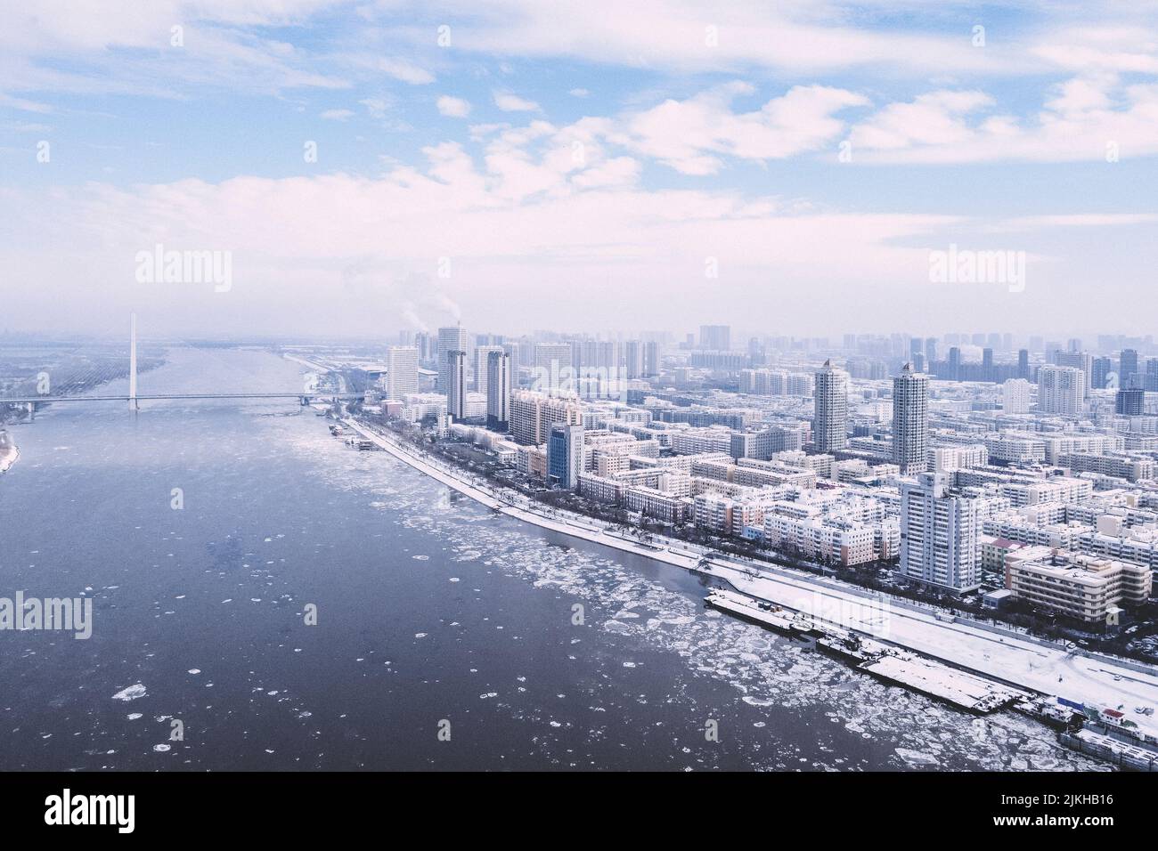 A beautiful view of a snowy city with a frozen lake Stock Photo