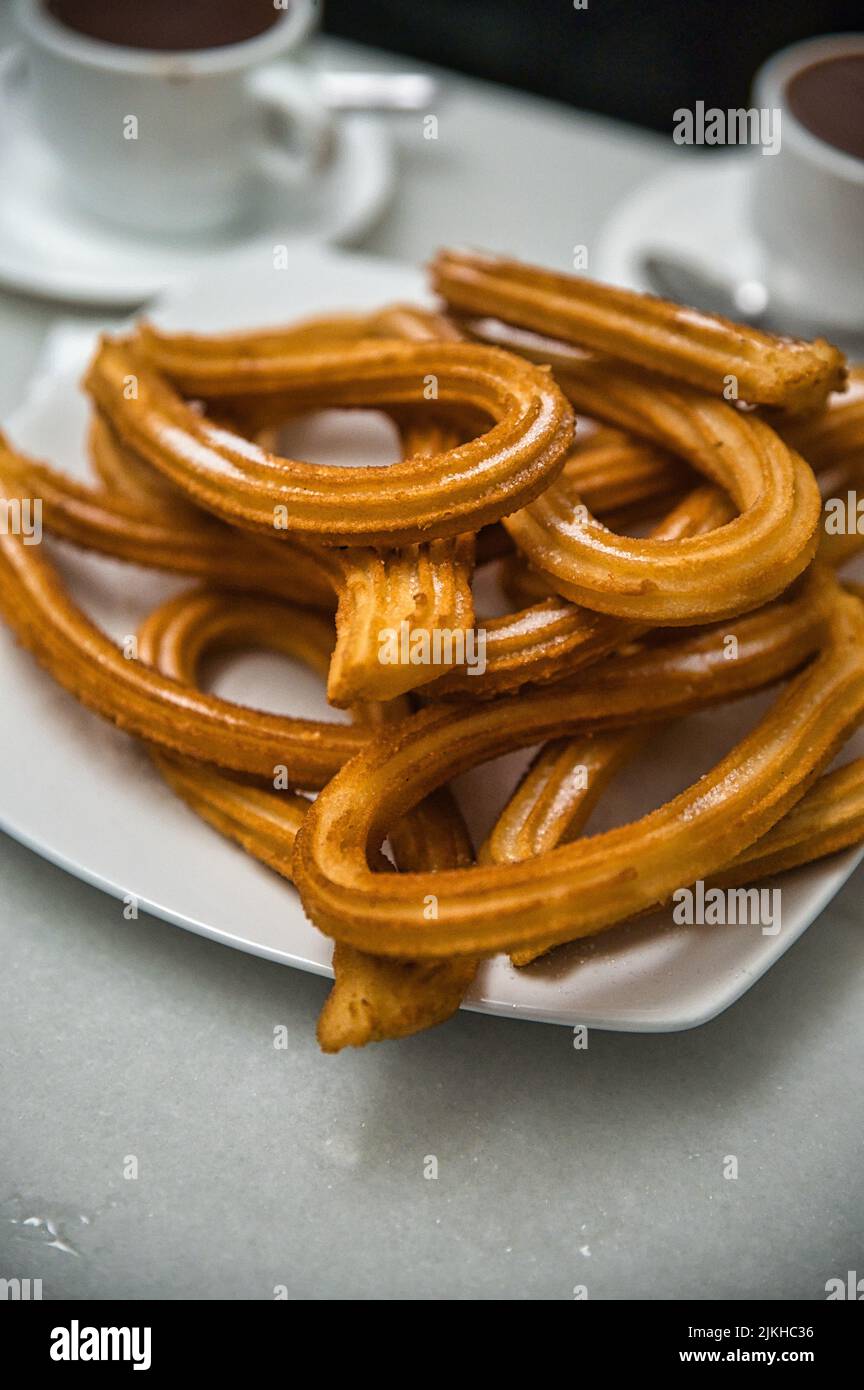 A vertical shot of churros and a cup of kakao in Valencia, Spain Stock Photo