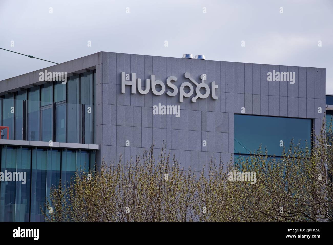 HubSpot signage at the top of a modern office building in Dublin city centre on cloudy day. The HubSpot is CRM platform for scaling companies. Stock Photo