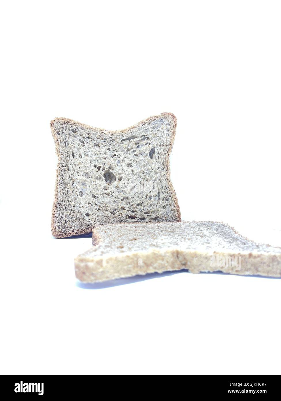 The two slices of brown bread isolated on white background Stock Photo ...