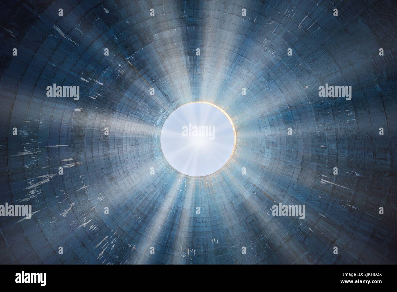 A low angle shot of a blue cooling tower in abandoned power plant with