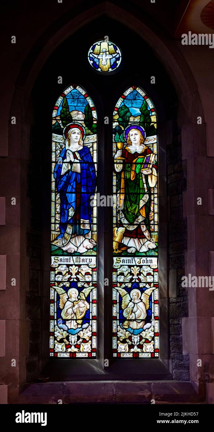 A vertical shot of stained glass windows in the Saint Winifred's Church