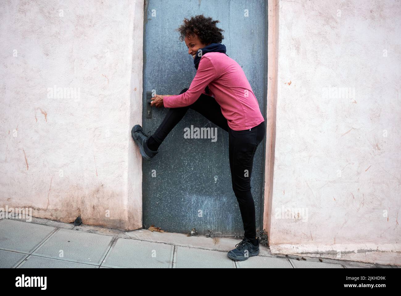 A beautiful happy female trying to open a locked door Stock Photo - Alamy
