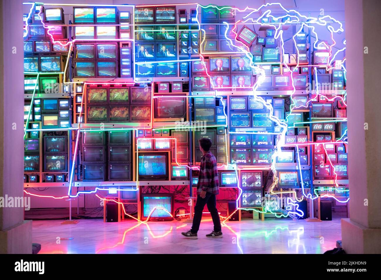 A South Asian male walking against an Electronic Superhighway at Renwick Gallery of Smithsonian American Art Museum Stock Photo