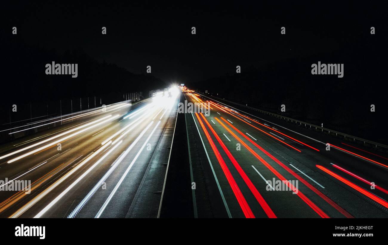 The light trails of cars on a highway at night Stock Photo - Alamy