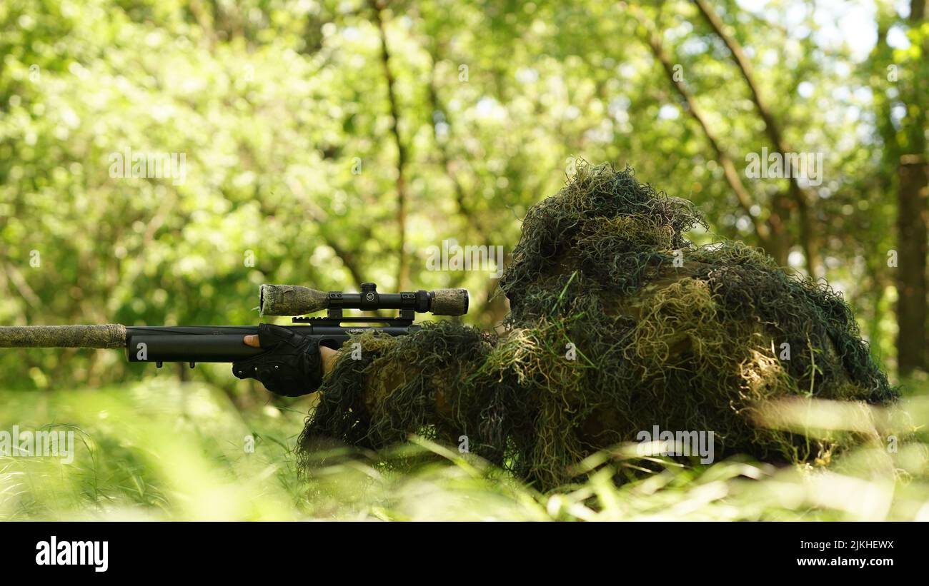 A closeup shot of a ghillie suit with grass to play Airsoft in Ploiesti, Romania Stock Photo