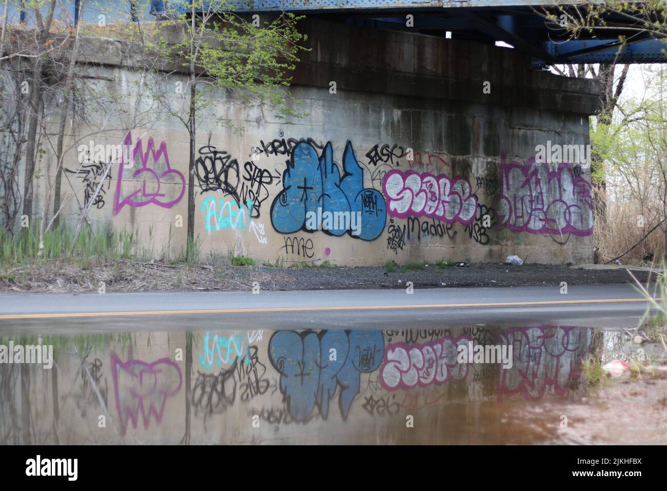 A beautiful view of the reflection of graffiti under overpass Stock